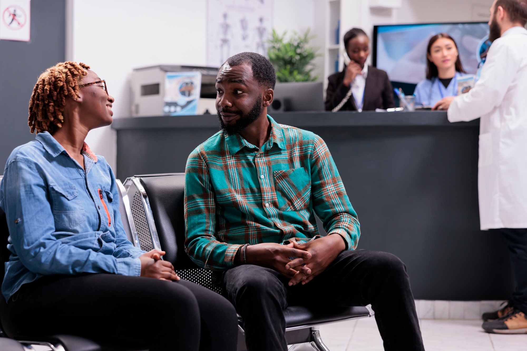 African american youths conversing, awaiting admission to clinic